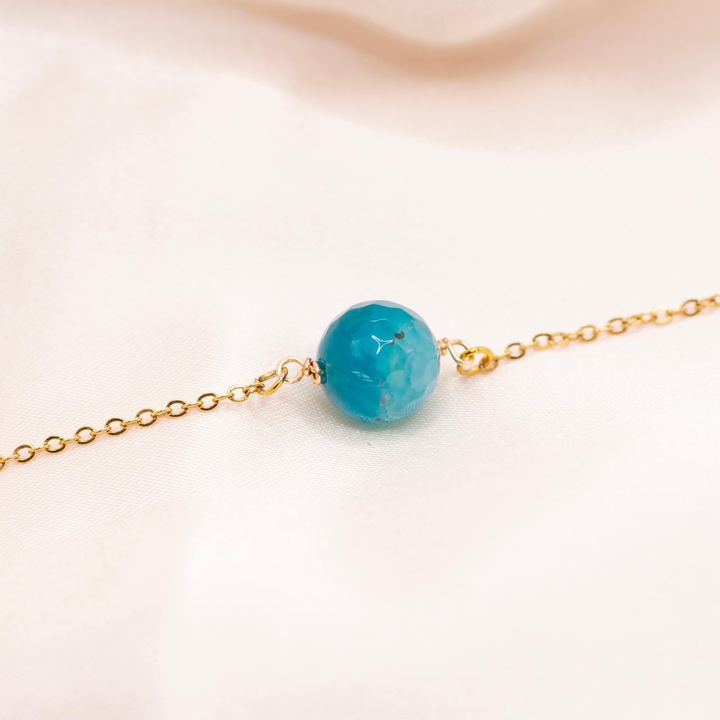 Blue gemstone bead necklace with dainty, gold-plated stainless steel chain.