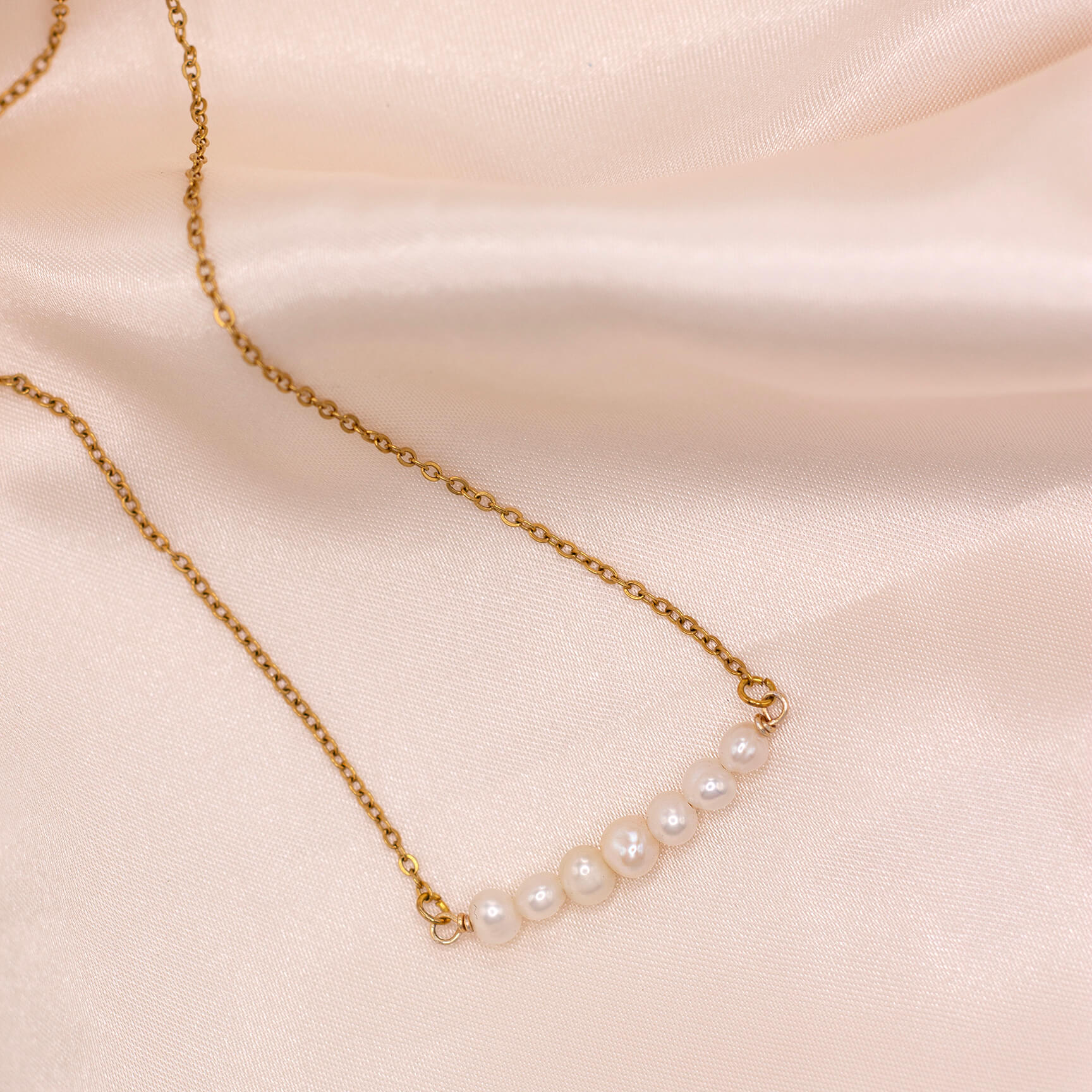 Minimalist pearl bar necklace with dainty freshwater pearls and gold-plated stainless steel chain. Waterproof and hypoallergenic.