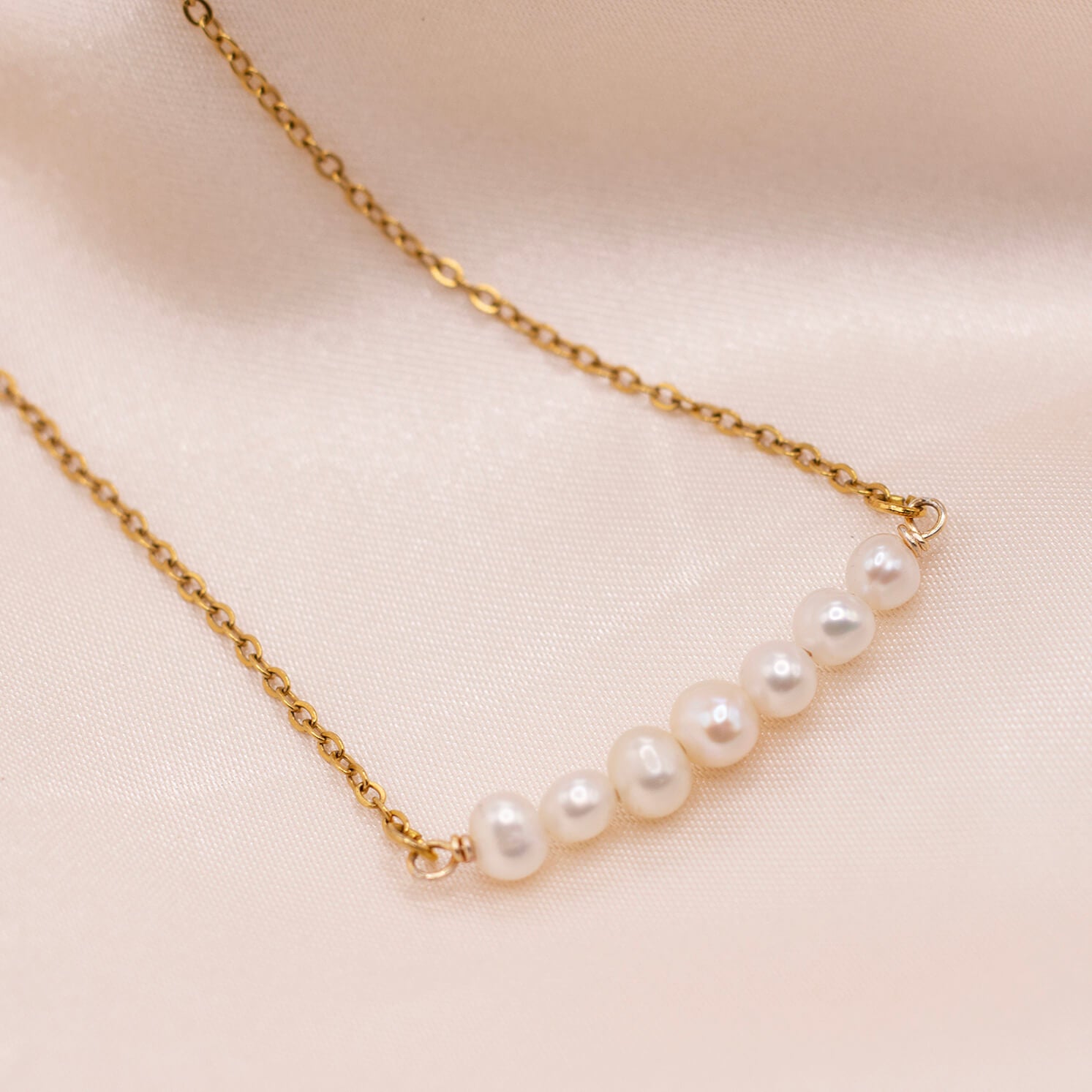 Minimalist pearl bar necklace with dainty freshwater pearls and gold-plated stainless steel chain. Waterproof and hypoallergenic.