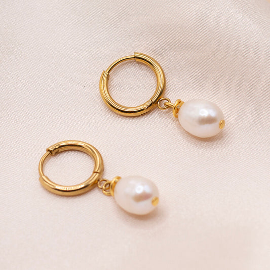 Minimalist pearl gold huggie earrings. Waterproof and hypoallergenic.