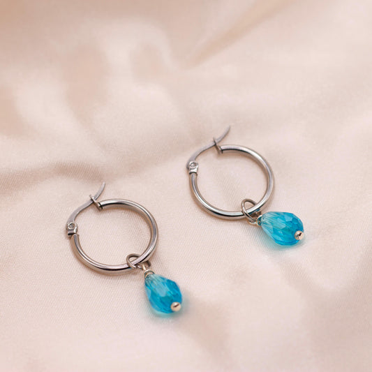 Minimalist turquoise teardrop silver hoops. Waterproof and hypoallergenic.