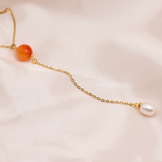 Orange red gemstone bead lariat necklace with dangling pearl. Hypoallergenic, gold-plated stainless steel. Water resistant.