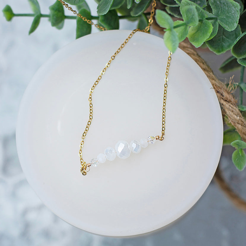 White crystal beaded bar necklace with dainty, gold-plated stainless steel chain.