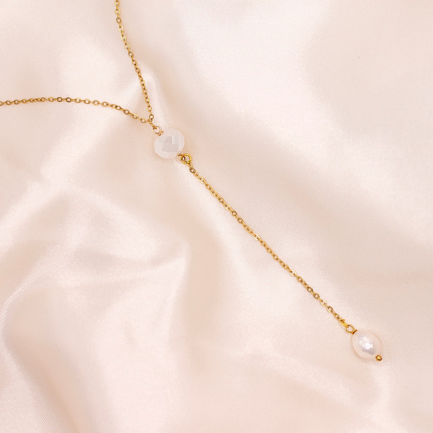 Pearl lariat necklace with white glass bead and gold-plated stainless steel chain. Hypoallergenic and water resistant.