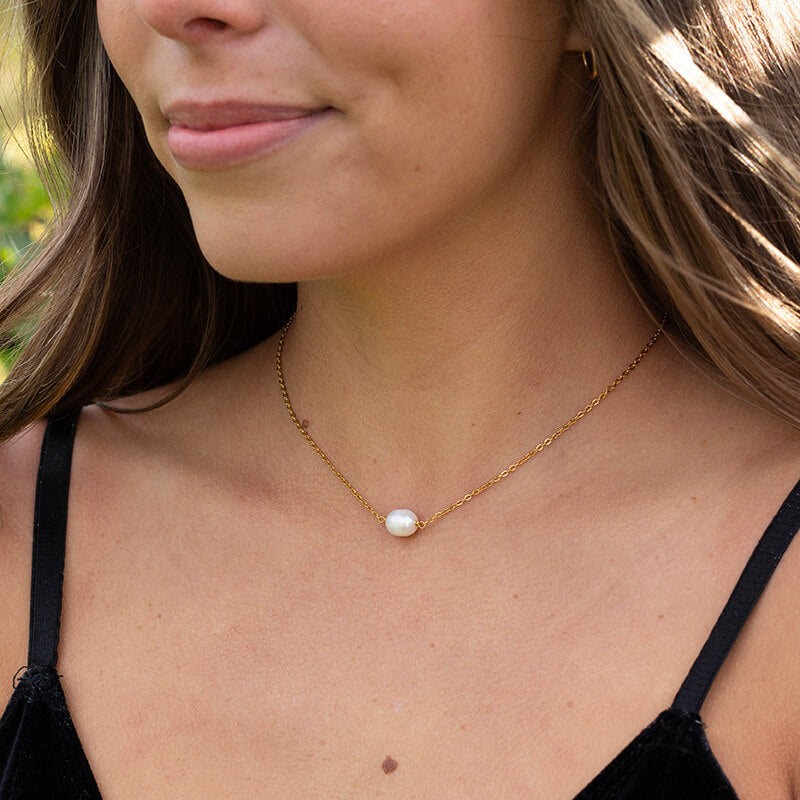 Woman wearing freshwater pearl necklace on gold waterproof chain